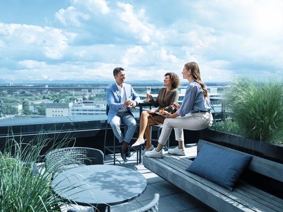 A man and two women are on a rooftop terrace wearing compression stockings.A man and two women are on a rooftop terrace wearing compression stockings.
