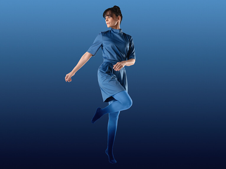 Frau trägt ein blaues Outfit und eine Kompressionsversorgung in Dip Dye Blau