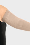 Woman wearing a Juzo compression sleeve with elbow functional zone