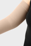 Woman wearing a Juzo compression sleeve with elbow functional zone