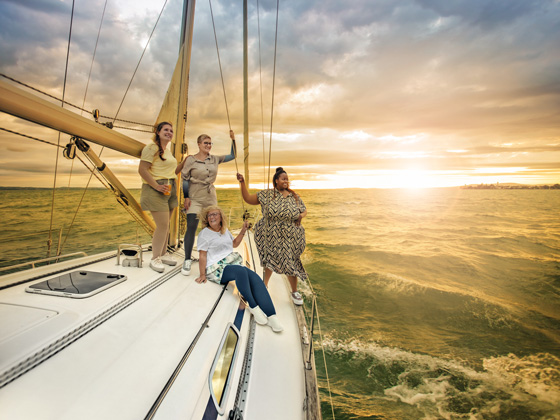 Four women with lymphatic conditions are on a boat at sea.