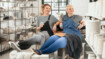 Two women sitting in a pottery studio. They are both wearing compression garments in the Dip Dye Colours